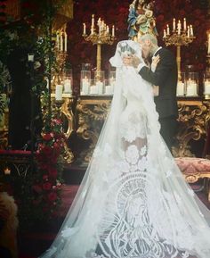 a bride and groom standing in front of an altar