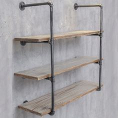 the industrial pipe shelves are made from wood and metal pipes, with one shelf on each side