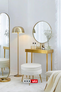 a white room with gold accents and mirrors on the wall next to a vanity table