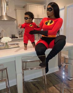 a woman and child dressed up as the incredibles