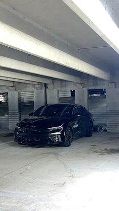 two cars parked in a parking garage next to each other