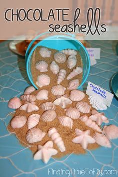 there are many seashells in the bowl and on the table next to each other