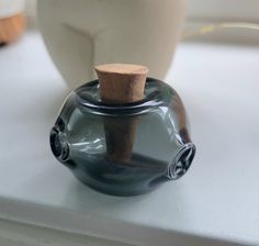 a glass vase with a cork in it