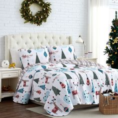 a bedroom with a christmas tree on the wall and white brick walls, along with a bed