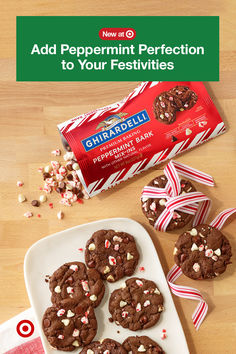 chocolate peppermint cookies with white and red candy canes on a plate next to a bag of peppermint bark