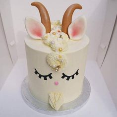 a white cake decorated with ears and flowers