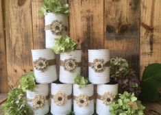 a stack of white pots with flowers on them