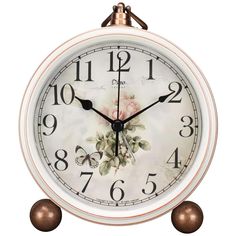 an analog clock with flowers on the face