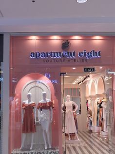 an apartment light storefront with mannequins in the window and on display