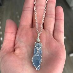 "☾ Blue Kyanite Necklace ☾ High quality, small, blue kyanite in its raw form in a secure & subtle setting that highlights the stone These pendants come in pure copper or sterling silver. Choose from an adjustable Faux leather chord (vegan friendly) or choose a matching 18\" copper chain or sterling silver chain. Faux leather chords are \"vegan friendly\" because they are actually cotton made to look like leather. These chords are also tied to be adjustable so you can wear it at your desired Blue Raw Stone Crystal Necklace As Gift, Blue Raw Stone Crystal Necklace Gift, Blue Mineral Crystal Necklace For Gift, Blue Wire Wrapped Crystal Necklace For Healing, Blue Kyanite Necklace For Gift, Sapphire Kyanite Necklace For Gifts, Sapphire Kyanite Necklace As Gift, Sapphire Color Kyanite Necklace For Gift, Blue Kyanite Jewelry