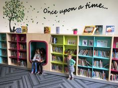 two children are sitting in their bookshelves and reading