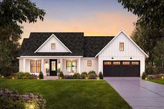 a white house with black shutters and two garage doors on the side of it