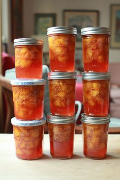 several jars filled with food sitting on top of a table