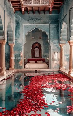 an indoor pool with red petals floating in it