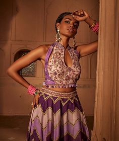 Make a style statement like a traditional diva in this alluring sharara set featuring geometrical print sharara coordinated with an intricately embroidered blouse with a stylised back design with heavy tassels and doris. Semi-stitched Purple Palazzo Set With Intricate Embroidery, Purple Georgette Palazzo Set, Bohemian Sharara With Unstitched Blouse For Diwali, Bohemian Sharara With Intricate Embroidery For Party, Bohemian Embroidered Sharara For Parties, Bohemian Party Sharara With Intricate Embroidery, Festive Purple Palazzo Set With Intricate Embroidery, Festive Purple Embroidered Palazzo Set, Bohemian Sets With Intricate Embroidery For Festive Occasions