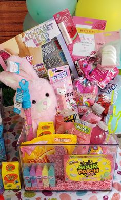 a basket filled with lots of toys and confetti on top of a table