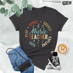 a t - shirt with the words dance, create music teacher on it and some shoes