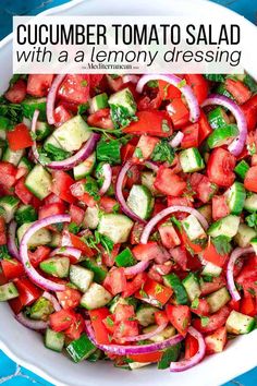 a white bowl filled with cucumber, onion and tomato salad on top of a blue cloth