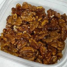 a plastic container filled with nuts on top of a table