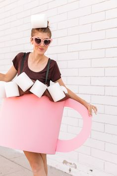 a woman is dressed up as a coffee cup with marshmallows on it