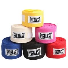 five different colors of wristbands with black, white, and yellow labels on them