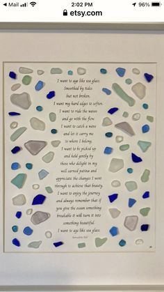 a framed poem with blue and gray sea glass in the shape of hearts on it