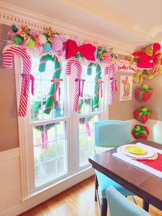 a dining room decorated for christmas with candy canes hanging from the ceiling and decorations on the windowsill