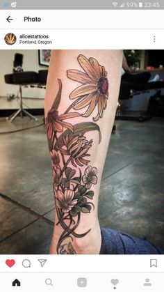 a woman's leg with flowers on it