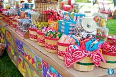 a table topped with baskets filled with candy