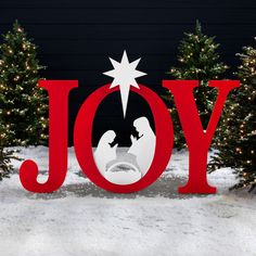 the word joy is displayed in front of christmas trees