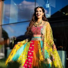 a woman in a colorful dress standing outside