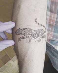 a tattoo on the arm of a man with a tiger in it's body