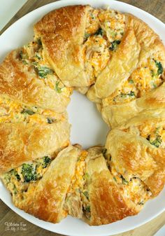 a white plate topped with broccoli and cheesy crescent pastry crusts