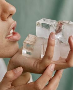 a woman holding ice cubes in her hands