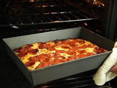 a pepperoni pizza is being cooked in an oven