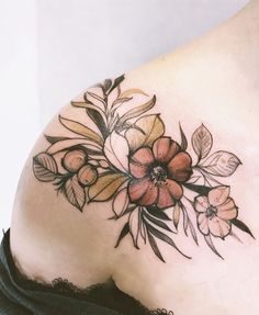 a woman's stomach with flowers and leaves tattooed on her back side ribcage