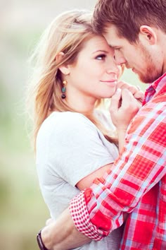 a young man and woman embracing each other