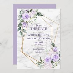 a wedding card with purple flowers and greenery on the front, in gold foil