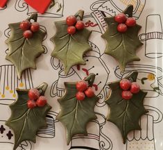 christmas cookies decorated with holly leaves and red berries