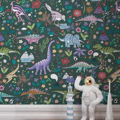 an astronaut is standing in front of a wall with dinosaurs and flowers on it