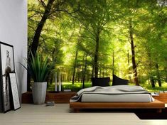 an image of a bedroom with green trees on the wall and bed in the foreground