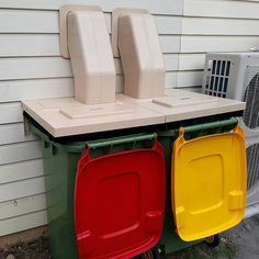 two air conditioners sitting next to each other in front of a house