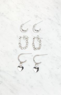 LA Hearts gives you options with the new 3 Pack Silver Earrings. This earring pack features three pairs of earrings in various designs and a silver finish.


	Includes 3 pairs of earrings
	Post back closure
	Silver finish Earring Pack, Y2k Earrings, Dainty Earrings, Women Accessories Jewelry, Earings Piercings, Pacsun, Post Earrings, Women's Accessories, Silver Earrings