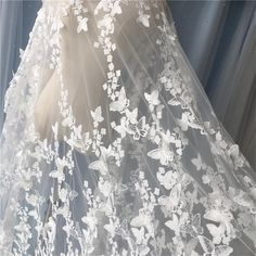 a white veil with flowers and butterflies on it