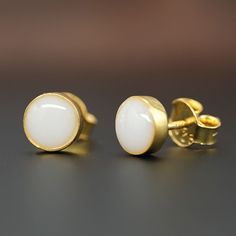 Beautiful handmade item! Here, on Etsy made as simulation only-just resin and white color.  Breast Milk Jewelry Stud Pearl Earrings 24k gold or rose gold plated over sterling silver with 6,7 or 8 mm stone. Set in simple, skin-friendly 925 sterling silver studs, our She's a Pearl earrings showcase the natural beauty of your breastmilk. Choose to keep your breastmilk pearls plain or add in pearl powder to give your pearls a lustrous, pearlescent finish. Available in 6, 7, or 8mm pearls set in ster White Cabochon Earrings For Anniversary, Breast Milk Jewelry, Milk Jewelry, Breastmilk Jewelry, Pearl Powder, Pearl Set, Pearl Stud Earrings, Breast Milk, Earrings Collection