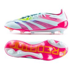 a pair of soccer shoes with pink and yellow lettering on the soles, side by side