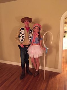 a man and woman dressed up as toy story characters standing next to each other on a hard wood floor