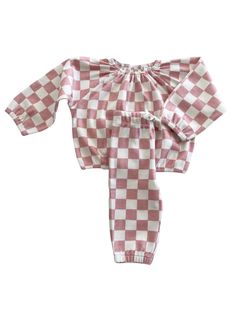 Checkerboard is bold and cheerful: perfect for your little one.The Organic Mode Top + Pant Set features soft 100% GOTS Certified Organic Cotton and is ready to be dressed up or down. Comfortable enough for a cozy day at home but also a complete outfit for running errands or playdates. Made in India 100% GOTS Certified Organic Cotton Machine Wash Cold By SIIX Collection Cozy Playtime Sets For Fall, Casual Pink Sets With Elastic Waistband, Casual Pink Set With Elastic Waistband, White Relaxed Fit Playwear Sets, Playful Cotton Bottoms In Matching Set, Playful White Relaxed Fit Set, Playful White Set With Relaxed Fit, Cozy Pink Sets For Spring, Pink Loungewear Set With Elastic Waistband