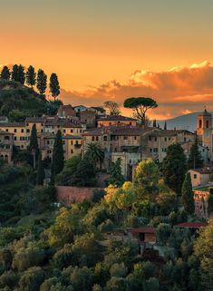 an old village on top of a hill at sunset