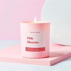 a pink candle sitting on top of a table